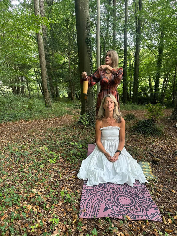 Heather with hands over a ladies head