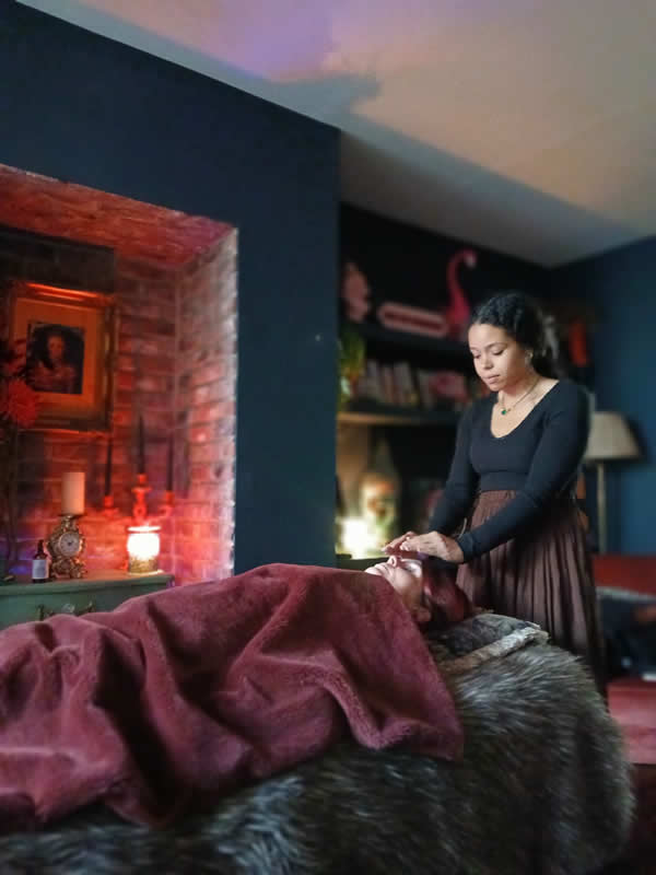 women giving reiki with black top on