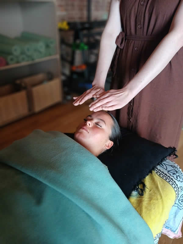 pic of girl with hands over her head receiving reiki