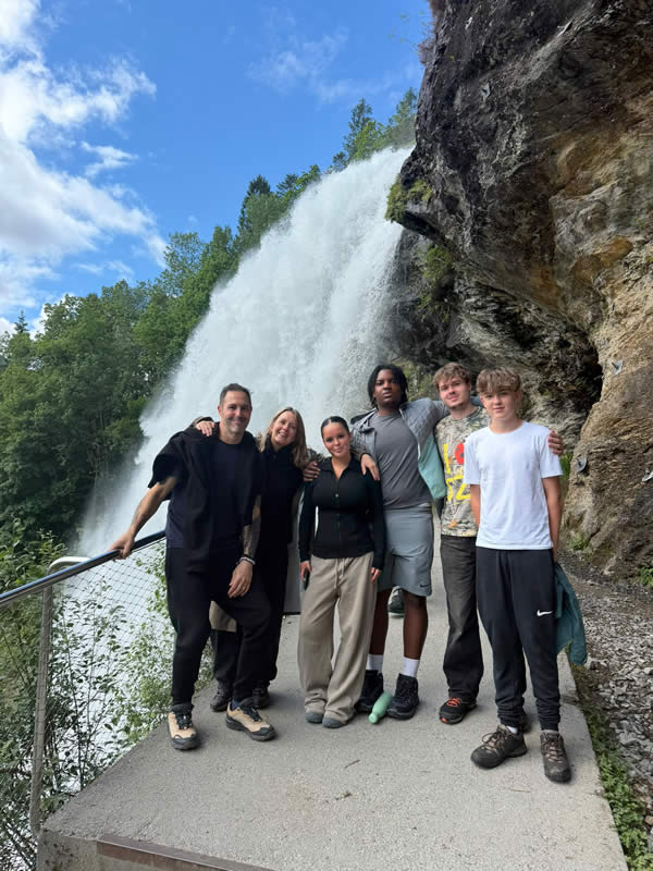 Heather and her family in front of waterfall