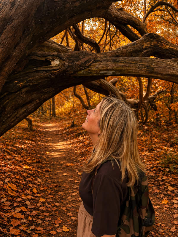 Heather in the woods looking at a tree